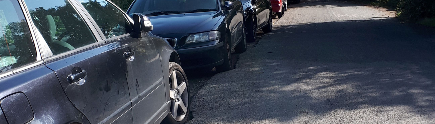 line of cars parked on Dell Quay Road
